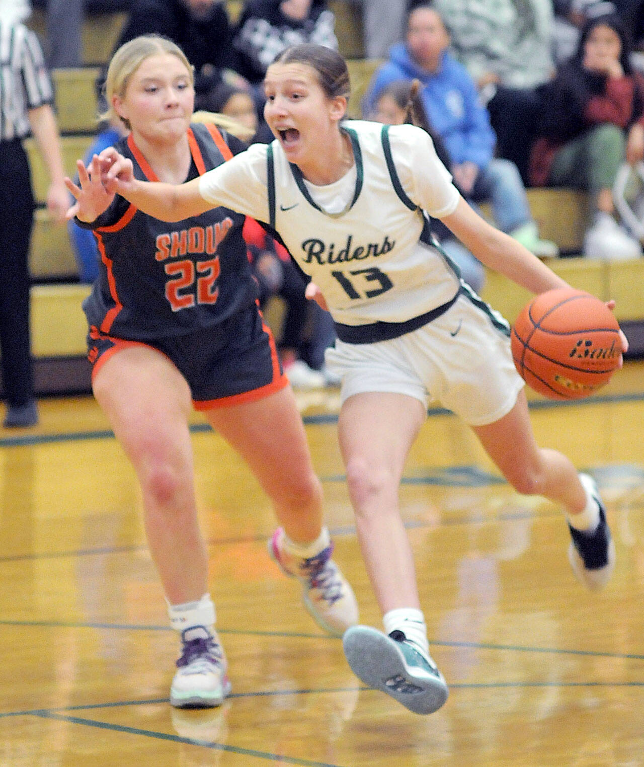 KEITH THORPE/PENINSULA DAILY NEWS Port Angeles’ Morgan Politika, right, charges to the key defended by Washougal’s Ireland Albaugh on Thursday at Port Angeles High School.