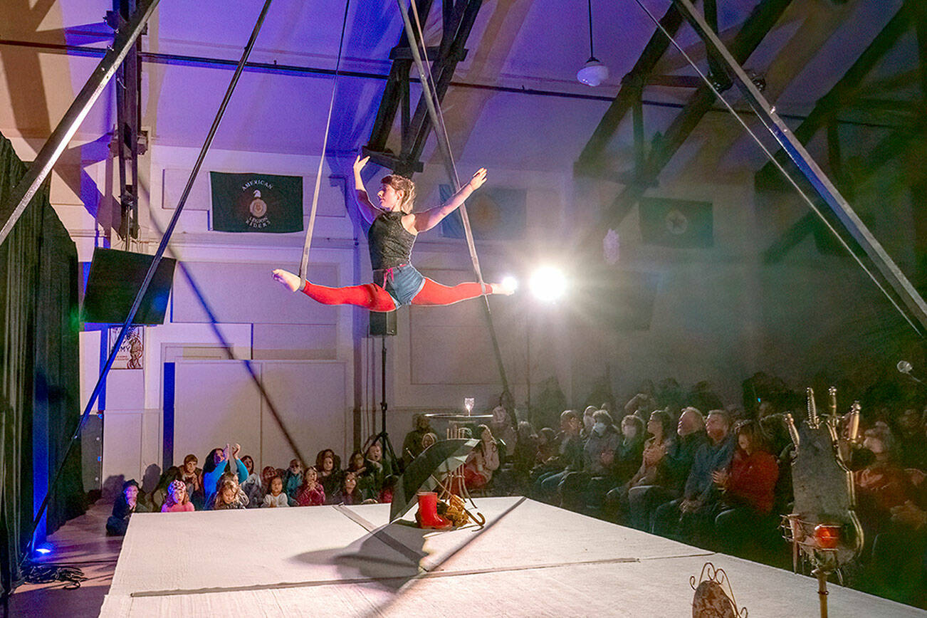 Juliane Hall of Seattle performs acrobatics on the straps during the First Night circus on Sunday at the American Legion Hall in Port Townsend. The Production Alliance created an all-ages experience for New Year’s Eve. (Steve Mullensky/for Peninsula Daily News)