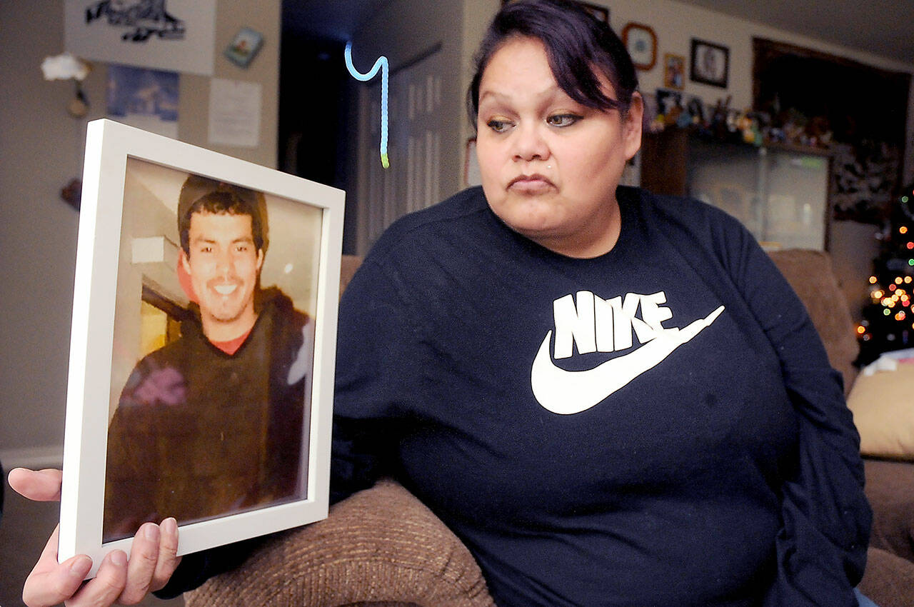 Nora Eastman of Port Angeles displays a photo of her son, Ted Eastman, 33, who died of an overdose of fentanyl, at their home on the Lower Elwha Klallam reservation. (KEITH THORPE/PENINSULA DAILY NEWS)
