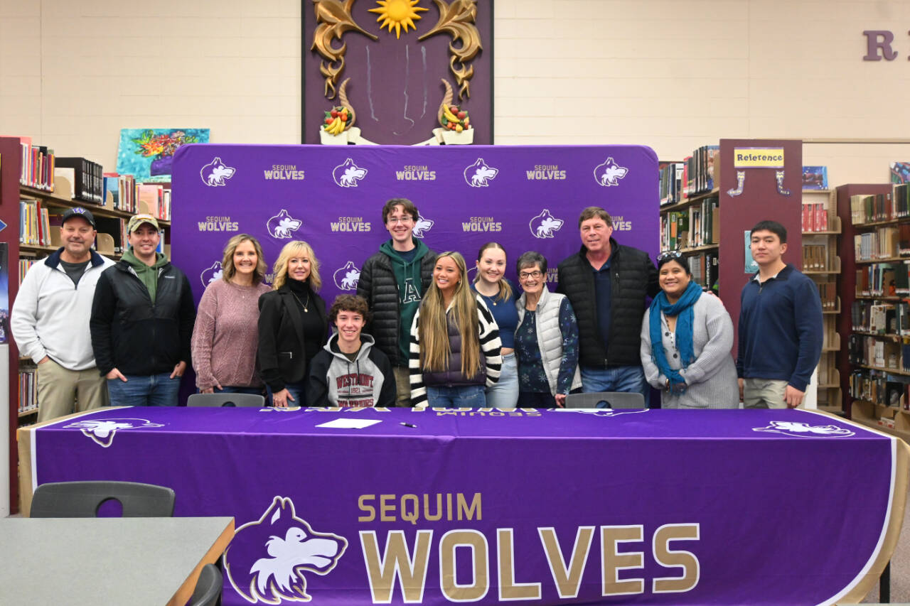 Sequim High senior Garrett Little (seated) is joined by friends and family at a letter-of-intent signing ceremony on Dec. 22. Little amassed an undefeated Olympic League record, three league titles, a district title and two top-three finishes (so far) at state tournaments, and he plans to play at Westmont College in Santa Barbara, Calif., after graduation. (Michael Dashiell/Olympic Peninsula News Group)