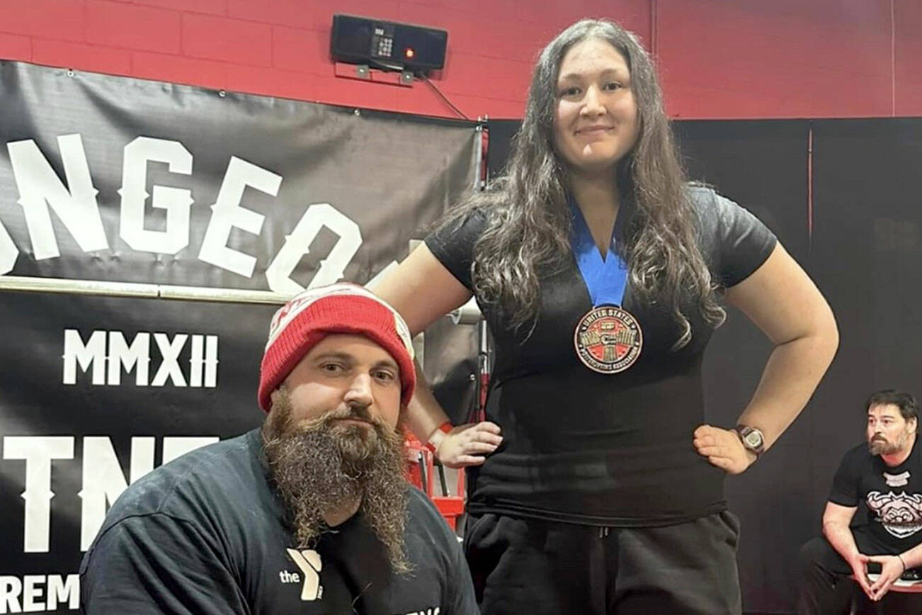 Port Angeles powerlifter Maggie Doyle set four U.S. Powerlifting Association age group records while winning her first powerlifting competition in Bremerton in December. She is shown with her coach, Ryan Fontana of the YMCA of Port Angeles.