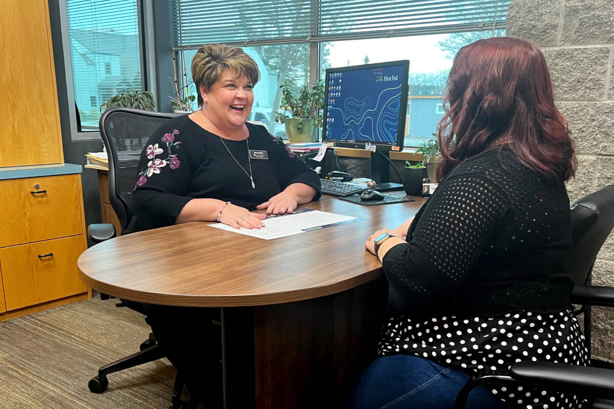 First Fed Branch Manager Robin Bookter reviews options with an account holder in Sequim.