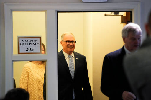 Gov. Jay Inslee arrives during a legislative session preview in the Cherberg Building at the Capitol on Thursday in Olympia. (Lindsey Wasson/The Associated Press)