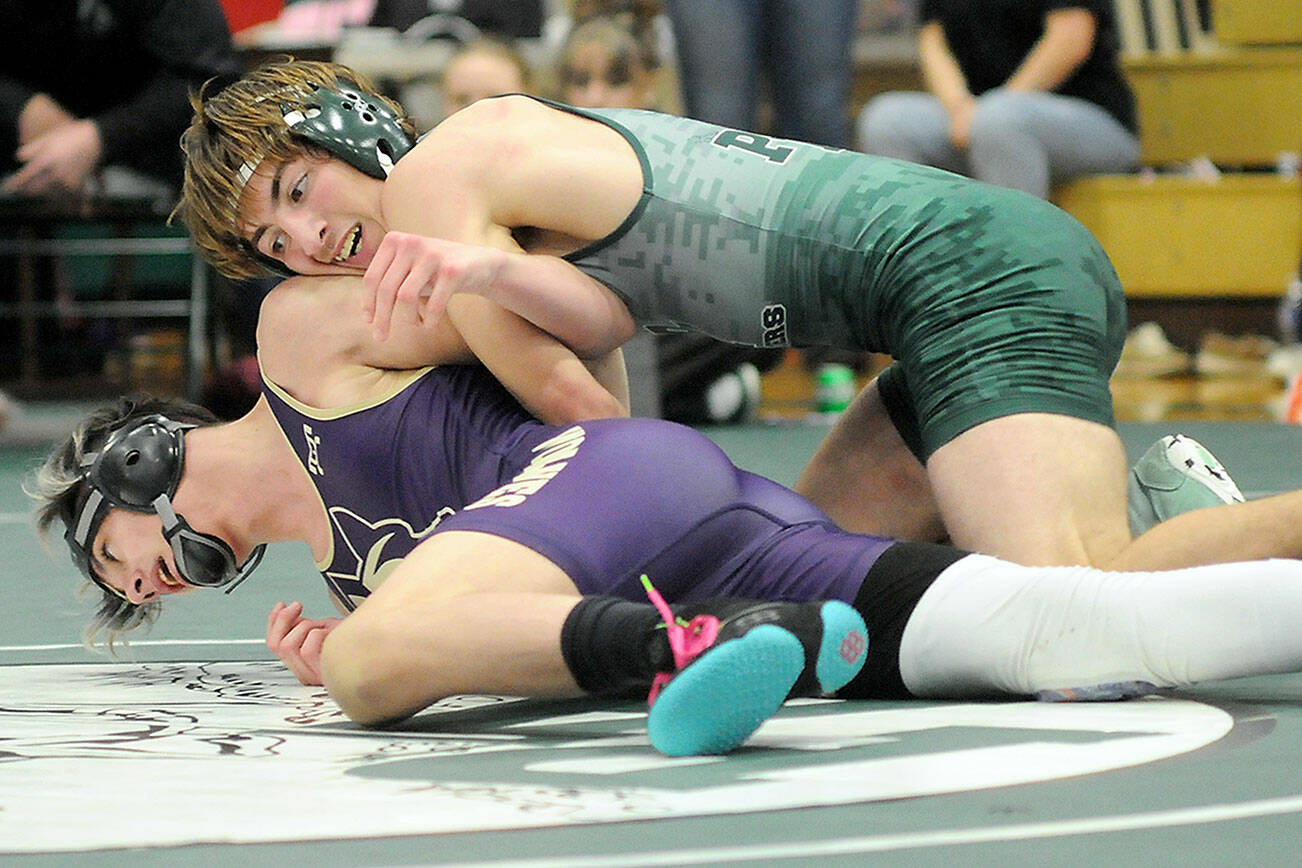 KEITH THORPE/PENINSULA DAILY NEWS
Port Angeles' Anthony McMahan, top, tries to overturn Sequim's Jayms Vilona in the 144-lb. class on Saturday at Port Angeles High School.