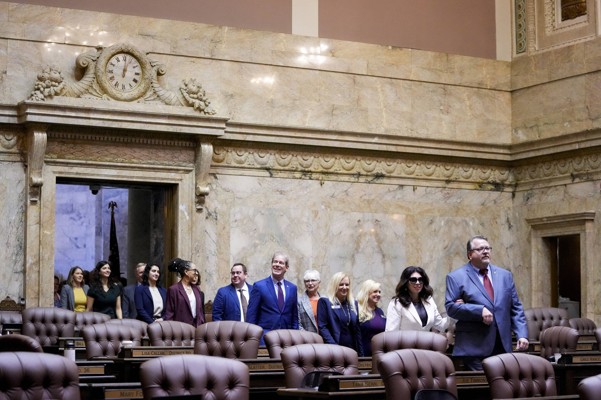 Members of the House, including Rep. Michelle Caldier, R-Gig Harbor, and Rep. Eric Robertson, R-Sumner, at front, walk into the House chambers during opening ceremonies on the first day of the legislative session at the Washington state Capitol on Monday in Olympia. (Lindsey Wasson/The Associated Press)