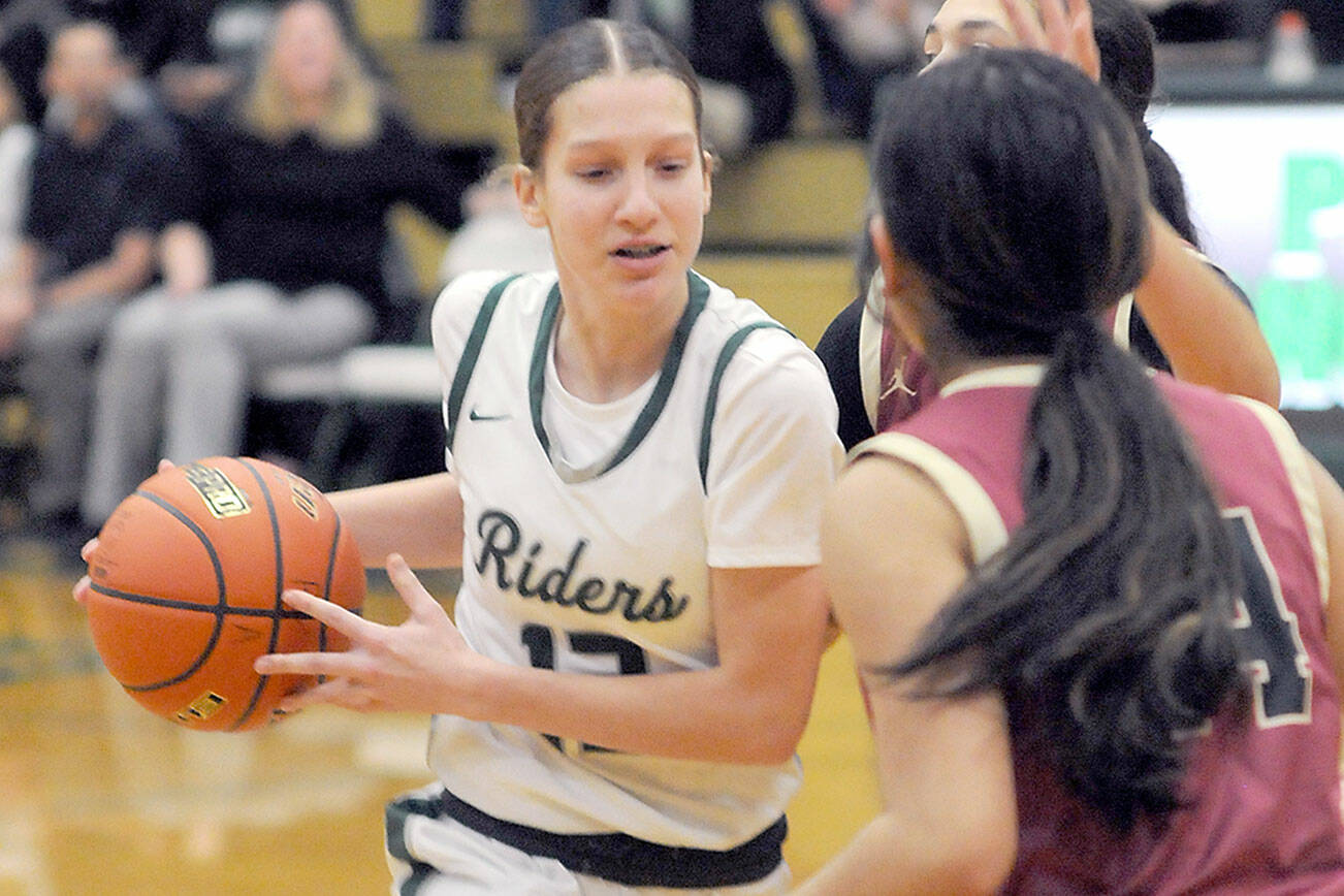 KEITH THORPE/PENINSULA DAILY NEWS 
Port Angeles' Morgan Politika, left, drives to the lane defended by Kingston's Tati Fontes-Lawrence, right, on Tuesday night in Port Angeles.