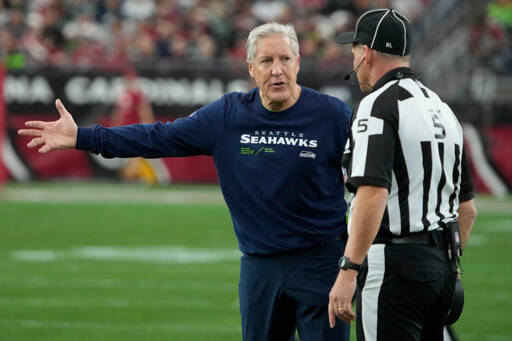 Seattle Seahawks head coach Pete Carroll argues a call with side judge Jim Quirk (5) in the first half of an NFL football game against the Arizona Cardinals on Sunday in Glendale, Ariz. (Rick Scuteri/The Associated Press)