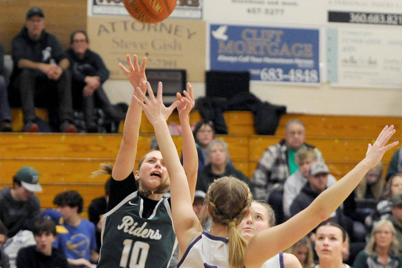 Michael Dashiell/Olympic Peninsula News Group
Port Angeles' Teanna Clark shoots while defended by Sequim's Jolene Vaara as Dani Herman looks on during the Riders' 66-64 Rainshadow Rumble rivalry win Thursday.