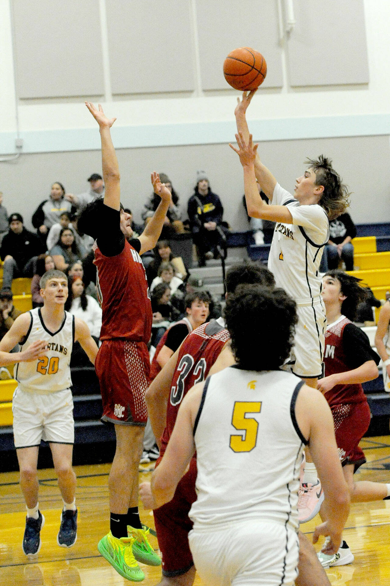 Forks’ Kyle Lohrengel scores over Hoquiam’s Chance LaBounty on Friday evening in a nonleague game in Forks. Also in action for Forks are Titus Rowley (20) and Landin Davis (5). (Lonnie Archibald/for Peninsula Daily News)