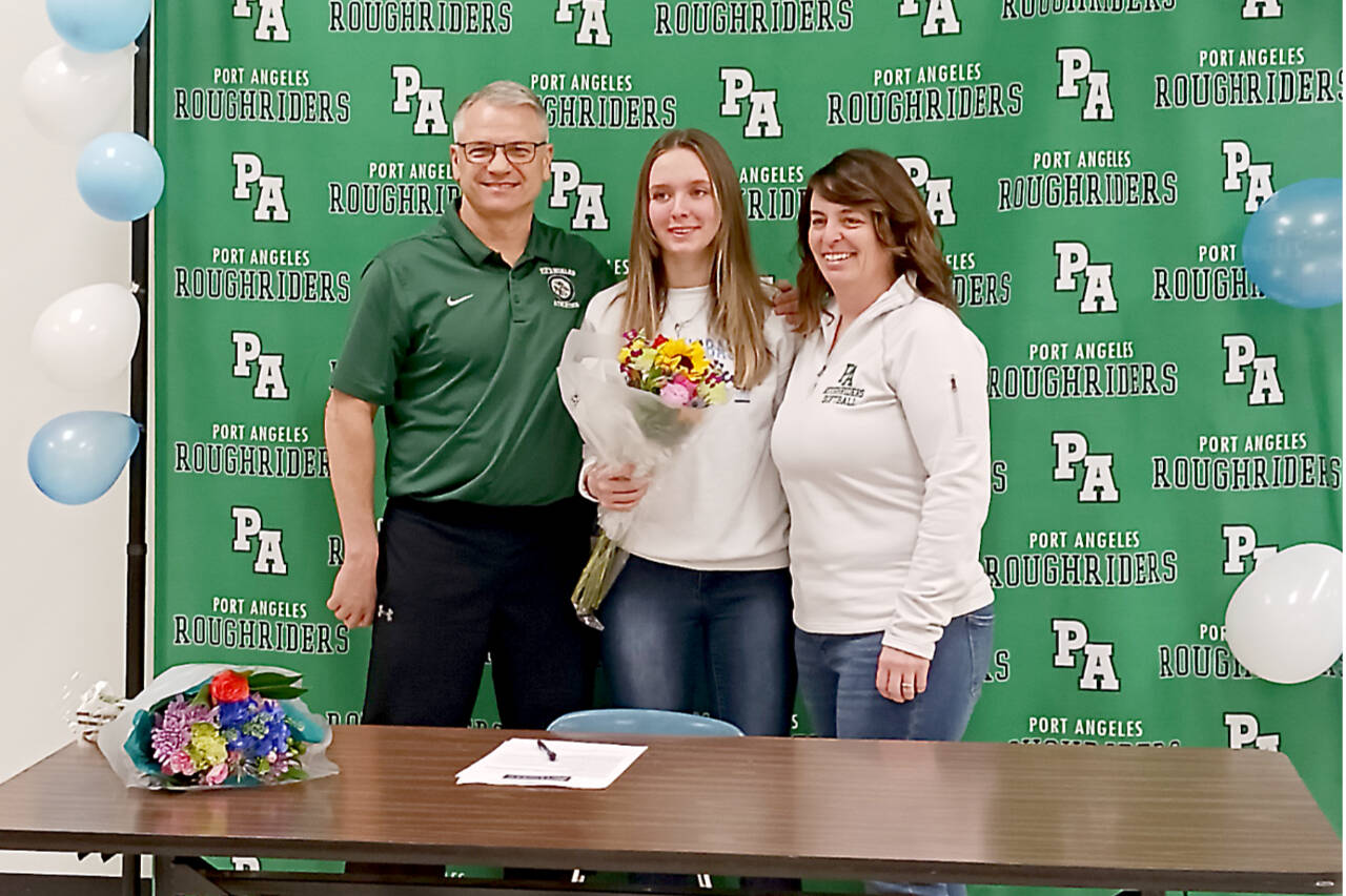 Natalie Robinson, center, celebrates signing to play softball at Columbia Basin College with her former high school coach Randy Steinman, left, and her current coach Morgan Worthington. (Pierre LaBossiere/Peninsula Daily News)