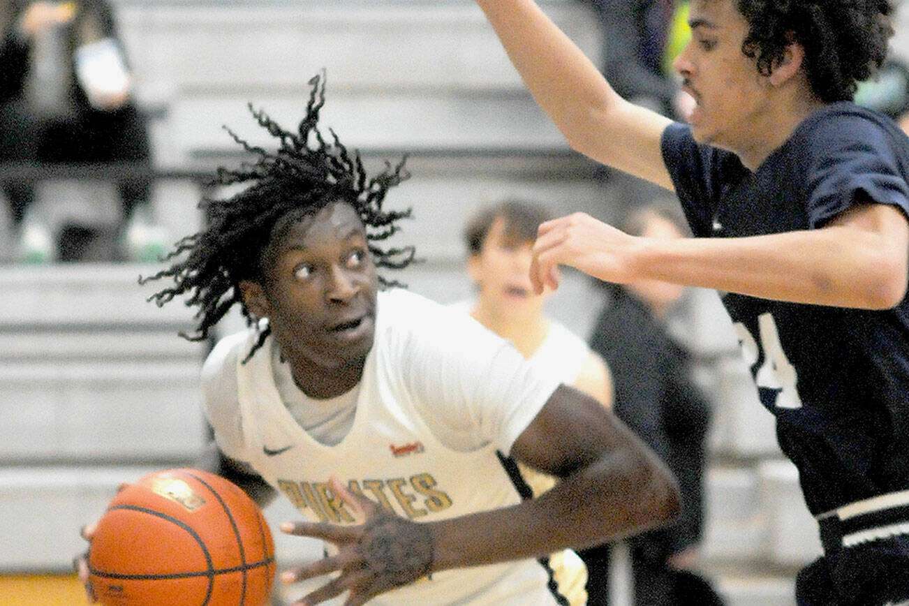 Peninsula’s Ese Onakpoma, left, eyes his opponent, Bellevue’s Mehki Alexander, during Wednesday’s game at Peninsula College. (Keith Thorpe/Peninsula Daily News)