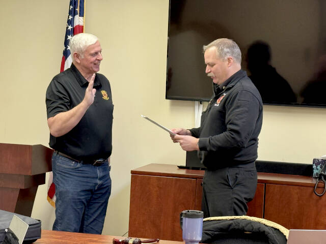 Fire Commissioner Dan Huff, left, is sworn in for a six-year term by Clallam 2 Fire-Rescue Chief Jake Patterson.