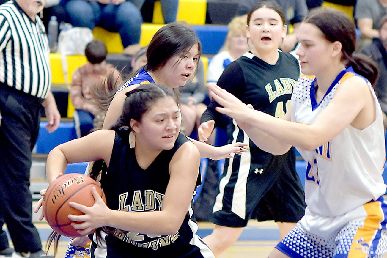 KEITH THORPE/PENINSULA DAILY NEWS 
Clallam Bay's Simona Cruz-Lopez, left, grabs a rebound and tries to evade Crescent's Chloe Ferro-May, right, while Crescent's Mia Chester and Clallam Bay's Aizhan Talantbek Kyzy look on from behind on Tuesday in the Crescent gym.