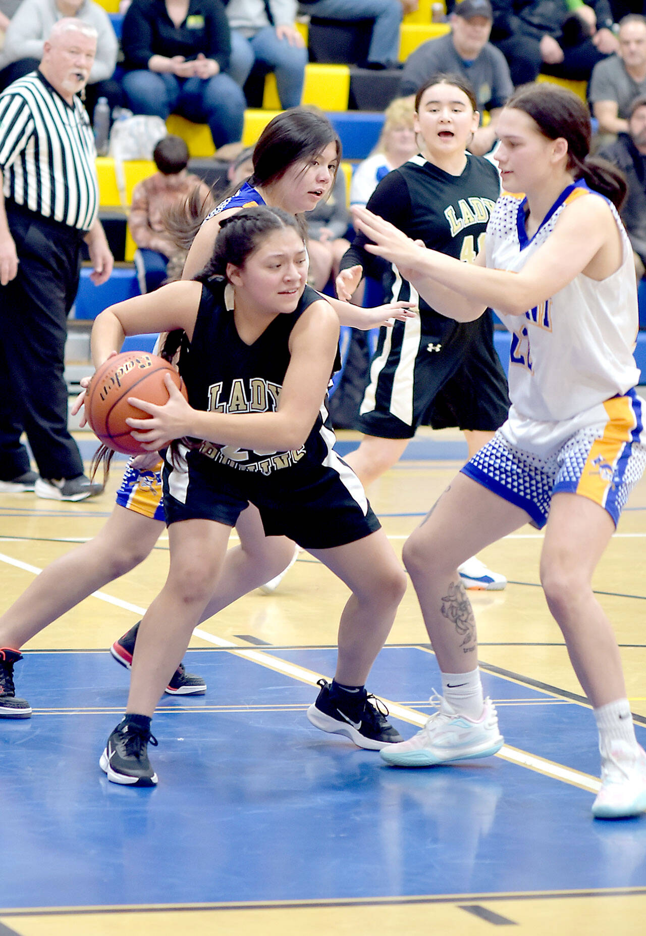 Clallam Bay’s Simona Cruz-Lopez, left, grabs a rebound and tries to evade Crescent’s Chloe Ferro-May, right, while Crescent’s Mia Chester and Clallam Bay’s Aizhan Talantbek Kyzy look on from behind on Tuesday in the Crescent gym. (Keith Thorpe/Peninsula Daily News)