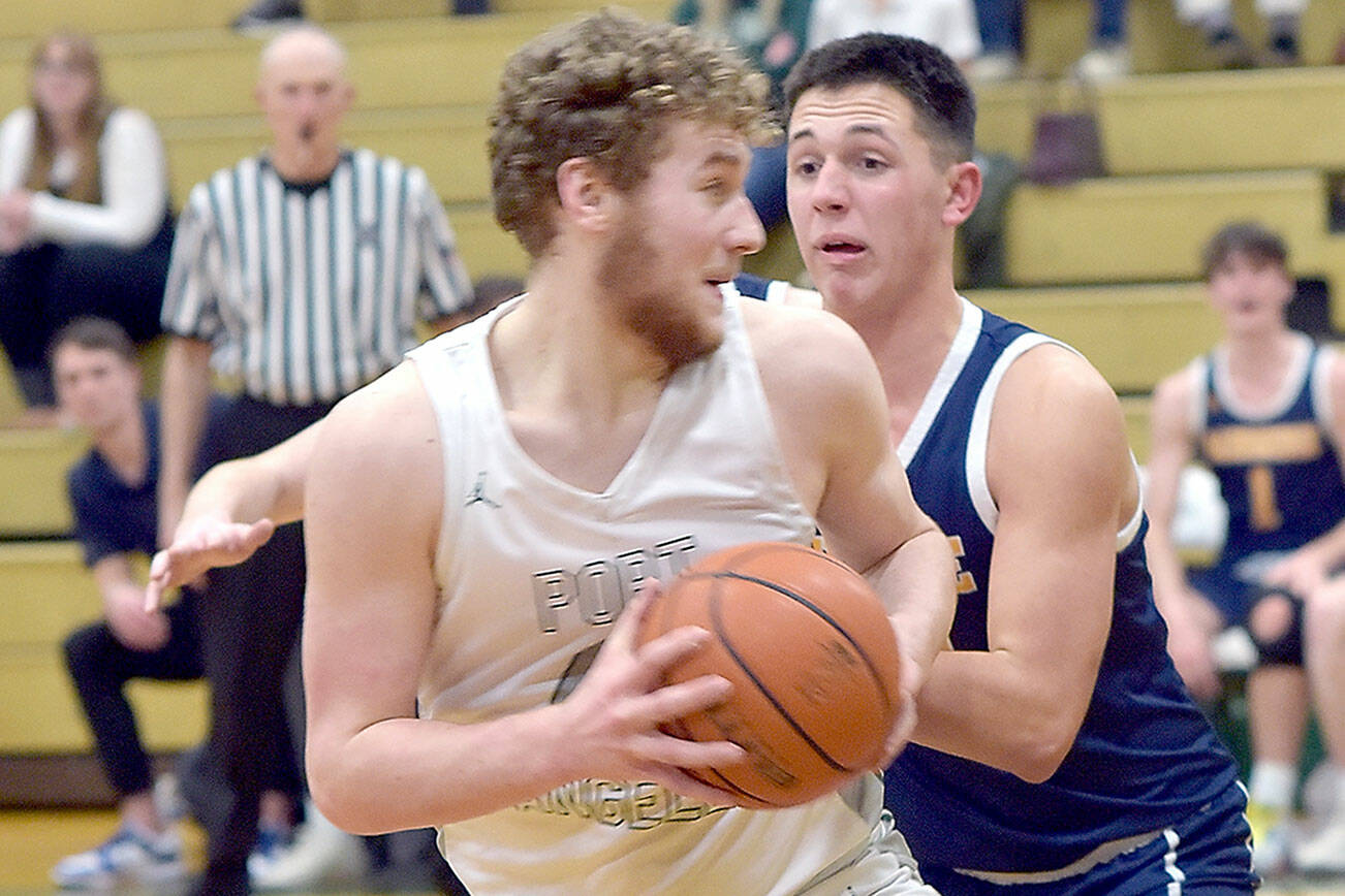 KEITH THORPE/PENINSULA DAILY NEWS 
Port Angeles' Isaiah Shamp, front, picks his path to the lane as Bainbridge's Will Rohrbacher tries to hold him off on Thursday in Port Angeles.