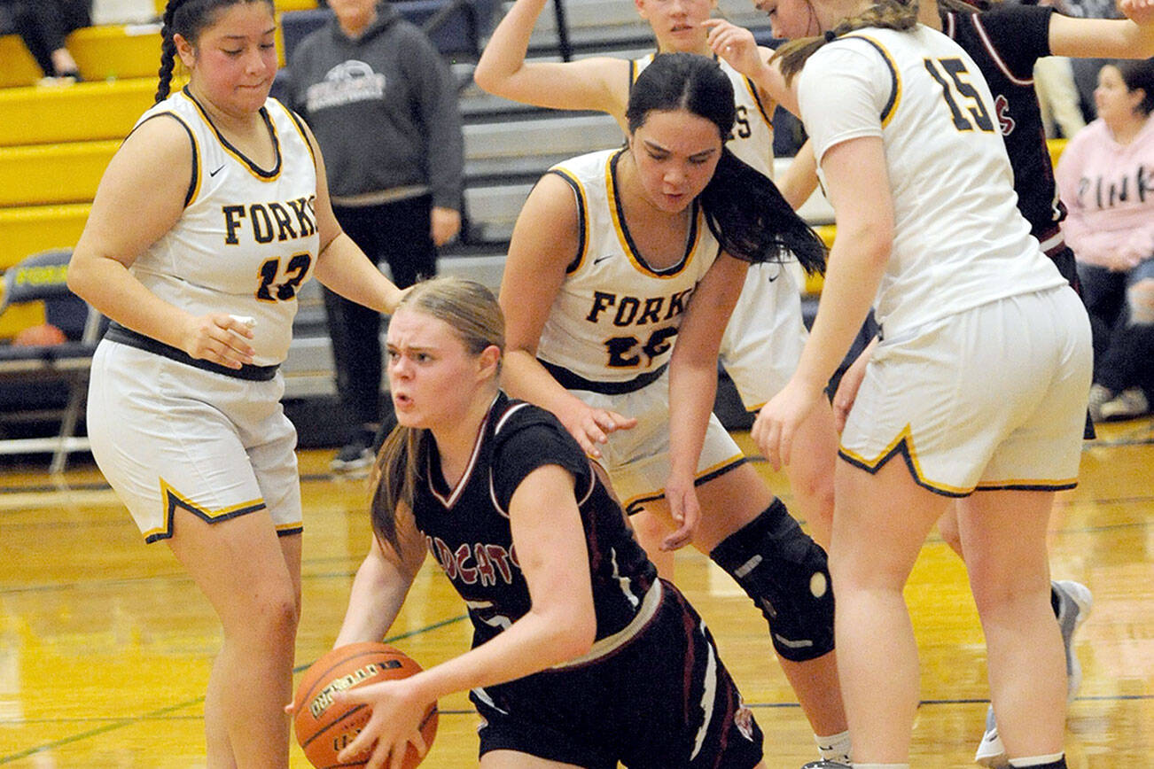 Lonnie Archibald/for Peninsula Daily News
Forks players from left, Janessa Ramos, Brynn Daniels and Fynlie Peters trap Ocosta's Anna Davis Friday night in Forks during senior night for the Spartans.  Looking on is Forks' Bailey Johnson.  Forks defeated Ocosta 59-31.