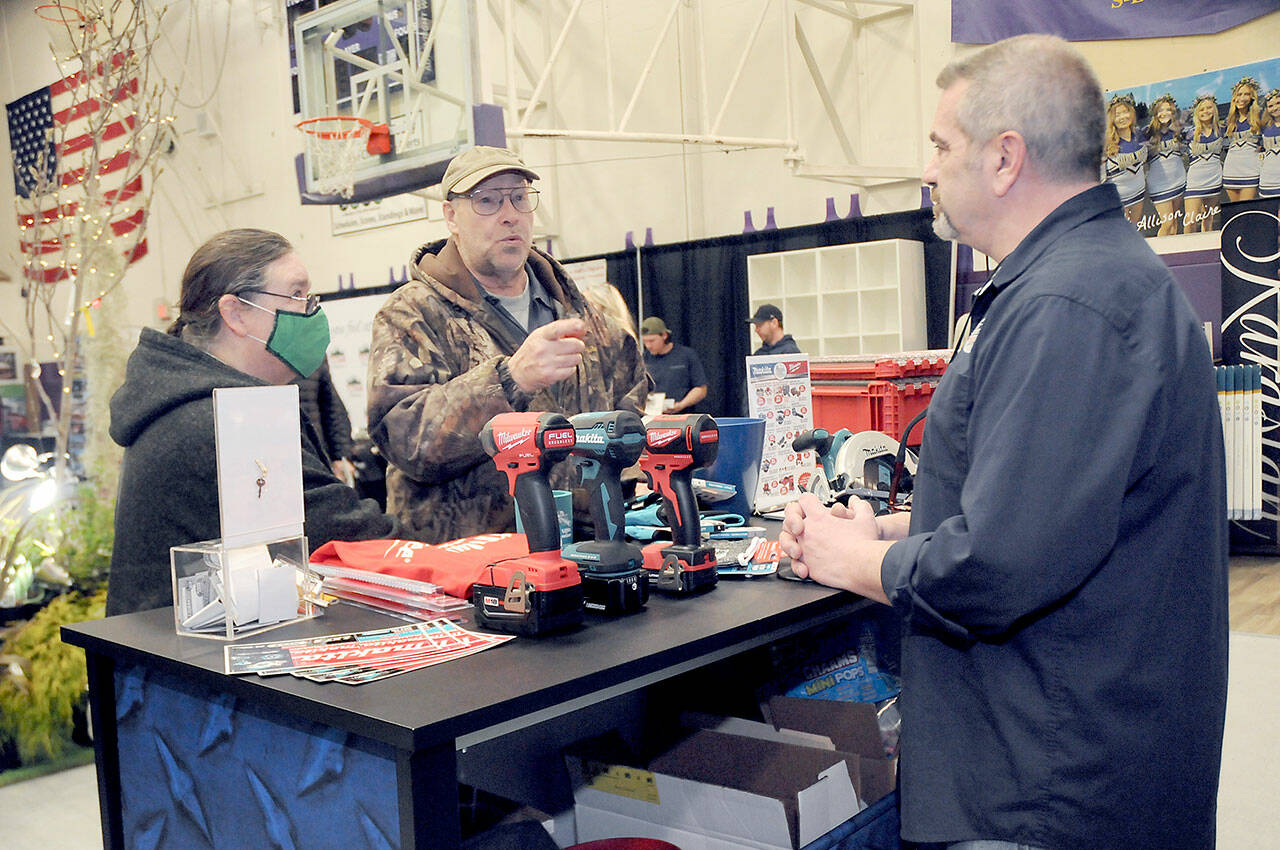 Jack and Marcella Ridge of Sequim talk about power tools with Tony Contestable, tool specialist with Hartnagel Building Supply of Port Angeles, right, during last year’s Building, Remodeling & Energy Expo in the Sequim High School gym. This year’s two-day event is scheduled for Saturday and Sunday. (Keith Thorpe/Peninsula Daily News)