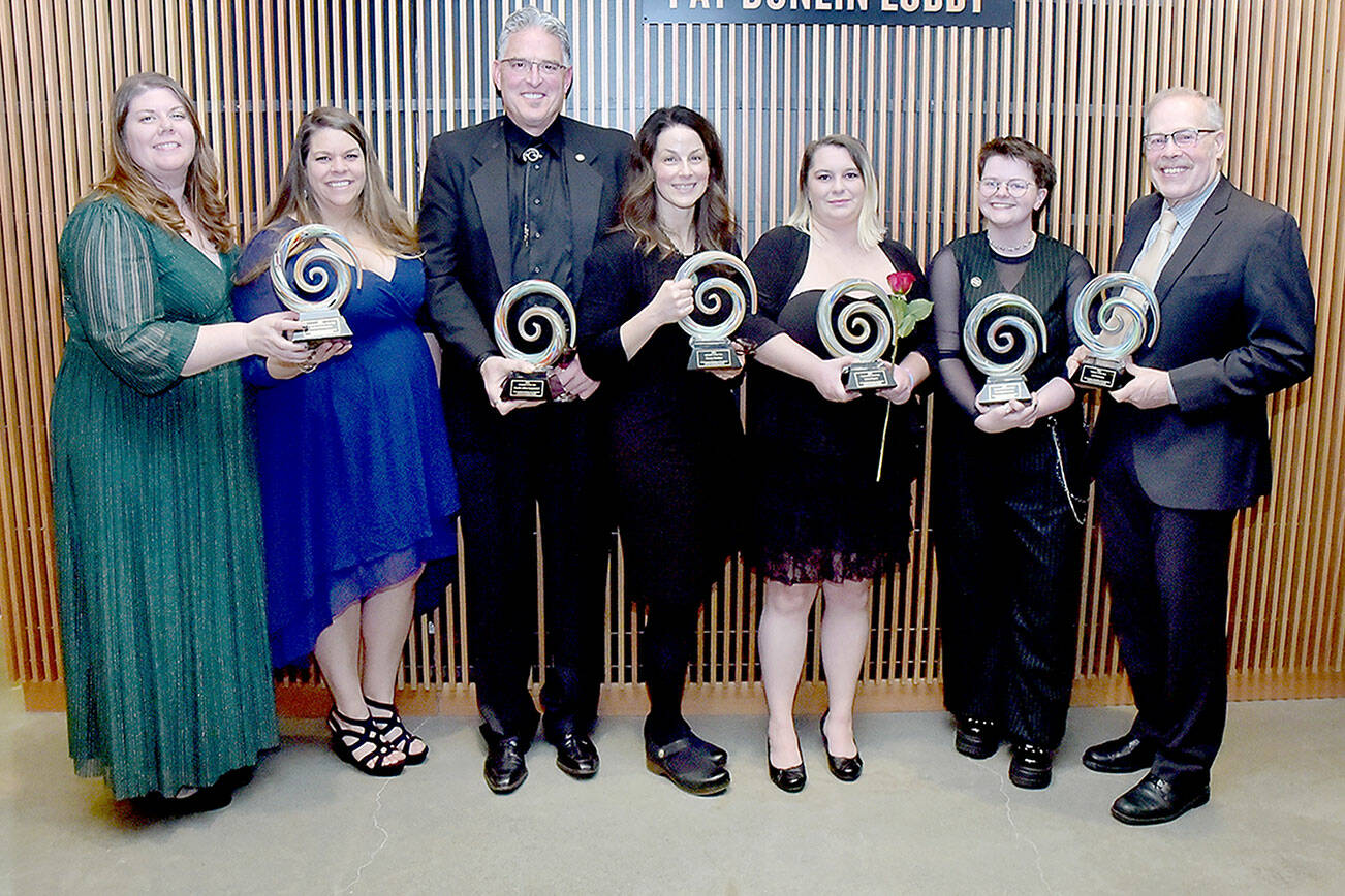 Winners of the 2024 Port Angeles Chamber of Commerce Community Awards gather after Saturday night’s ceremony at Field Arts & Events Hall in Port Angeles. The winners are, from left, Becky McFarland and Stevie Boggard of Kindred Collective, emerging business of the year; Tom Baermann of Pacific Office Equipment, business of the year; Stacey Sanders, educator of the year; Sheryl Hamilton of Oxford House, organization of the year; Kennedy Cameron, young leader of the year; and Jeff Bohman, citizen of the year. (Keith Thorpe/Peninsula Daily News)
