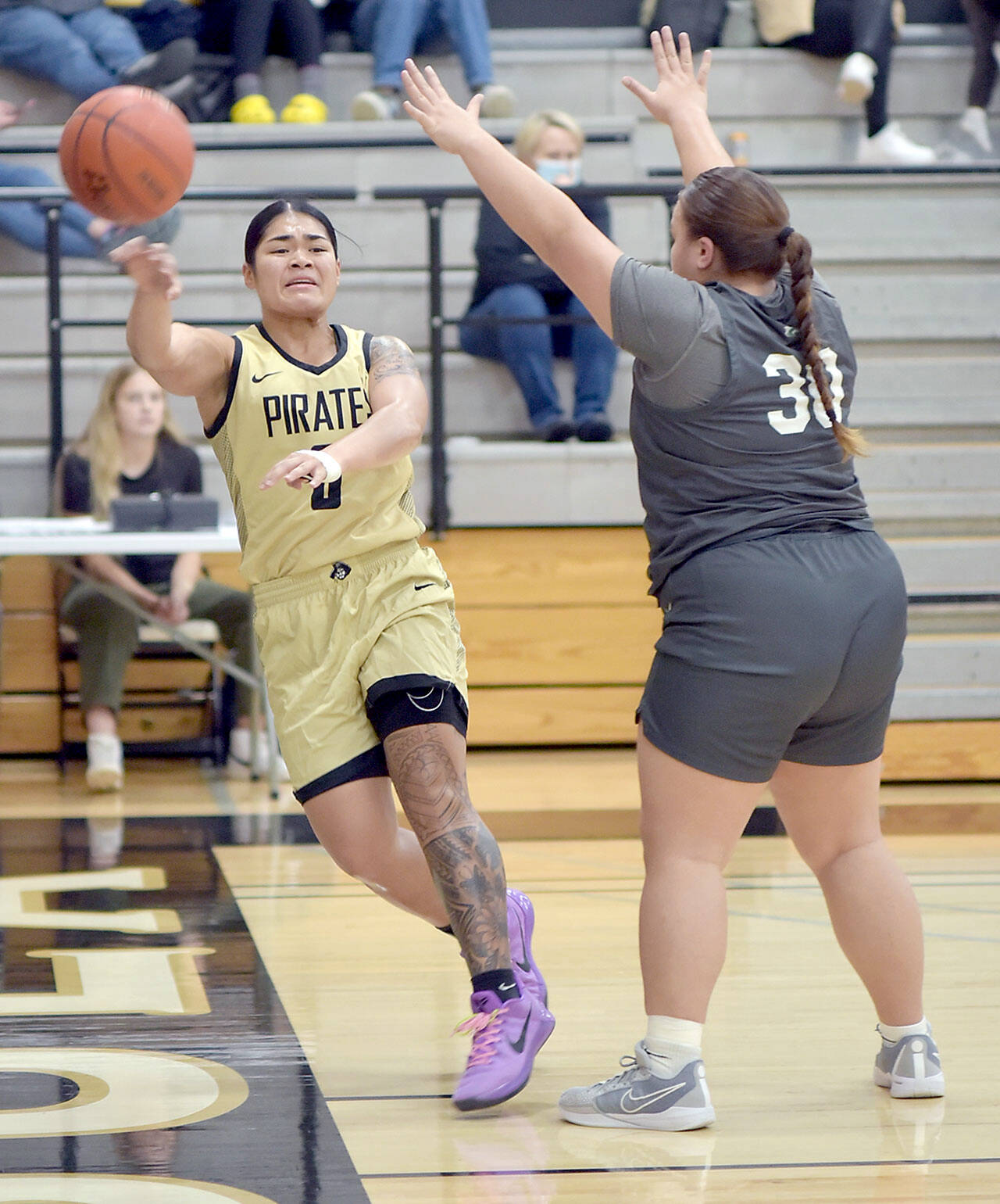 Peninsulas Ciera Agasiva, left, passes along the baseline as Shorelines Leiah Naeata tries to block on Wednesday night in Port Angeles. (Keith Thorpe/Peninsula Daily News)