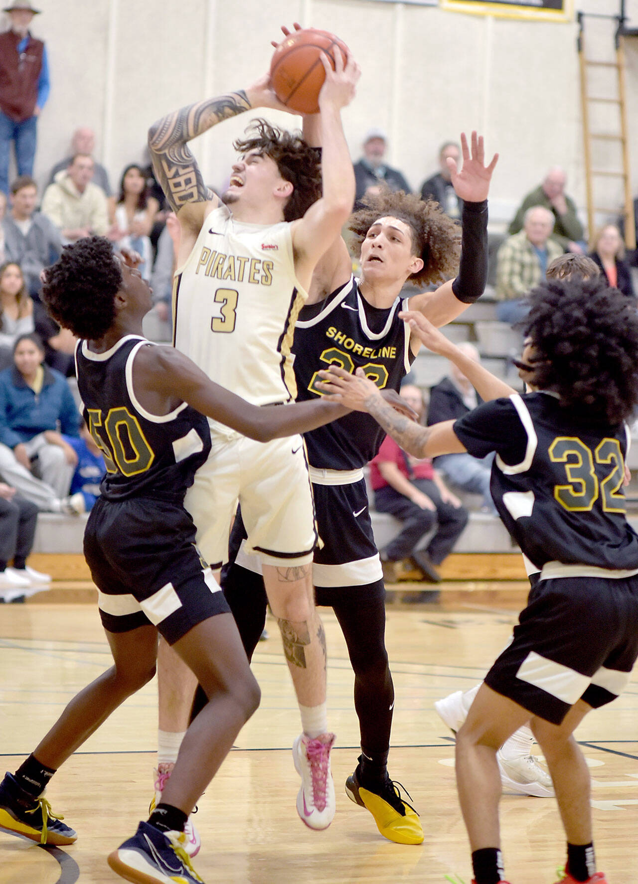 Peninsula’s Aiden Olmstead, center, shoots for the hoop surrounded by Shoreline defenders, from left, Abdoulee Cham, Joel Amaro and Jordon Smalls on Wednesday night in Port Angeles. (Keith Thorpe/Peninsula Daily News)