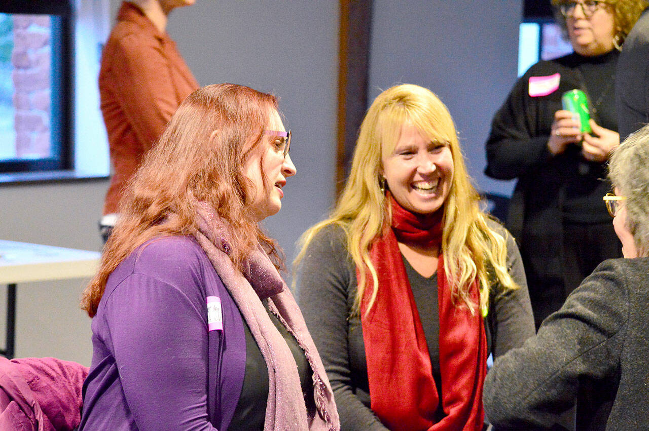 Port Townsend Library Director Melody Sky Weaver, left, and restaurateur Kris Nelson talked with community members at the Creative District plan unveiling Tuesday in Port Townsend. (Diane Urbani de la Paz/For Peninsula Daily News)