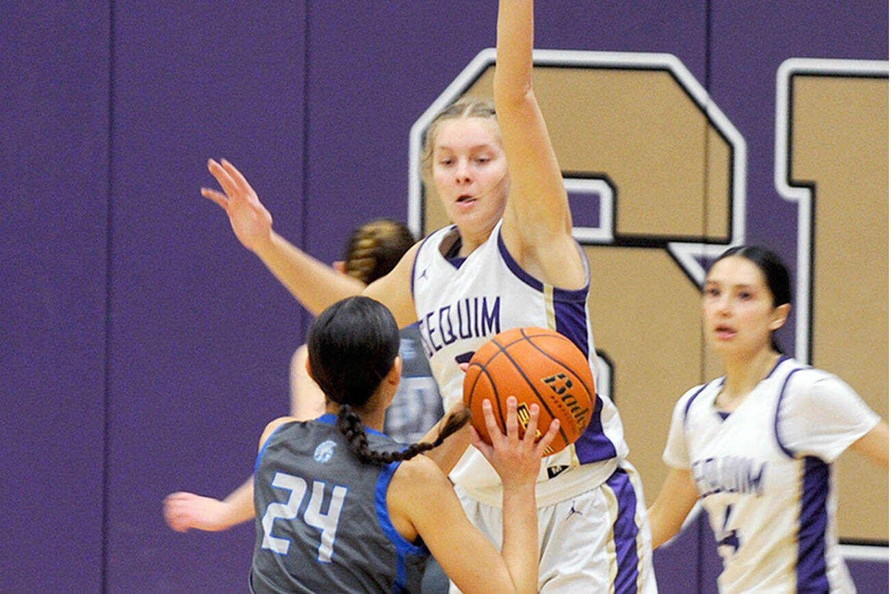 Matthew Nash/Olympic Peninsula News Group
Sequim's Jolene Vaara defends a shot taken by Olympic's Sophia Brown as the Wolves' Gracie Chartraw looks on during Sequim's 81-44 win Thursday.