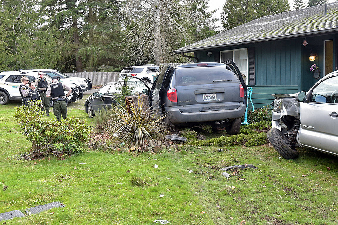 KEITH THORPE/PENINSULA DAILY NEWS 
Clallam County Sheriff's deputies investigate a van that left the roadway and struck two parked vehicles, with the driver fleeing the scene, leaving behind two children and alledgedly disposing of a hand gun on Friday on Deer Park Road east of Port Angeles.