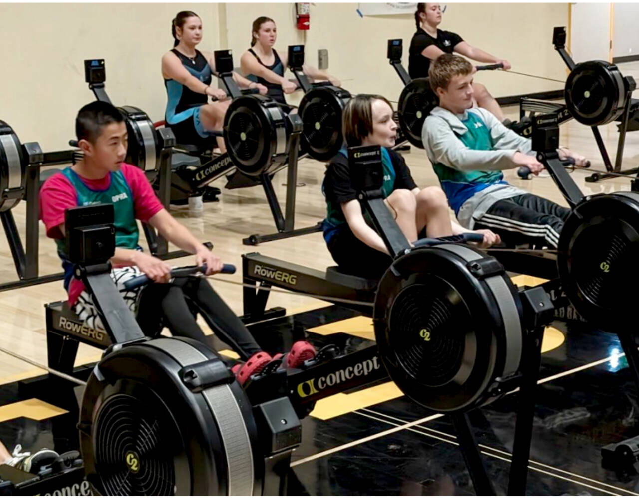 From left, Olympic Peninsula Rowing Association’s Mason Mai, 13, Quince Chanway, 12, and Teig Carlson, 14, warm up for the men’s under 15 2,000 meter indoor rowing event. (Olympic Peninsula Rowing Association)