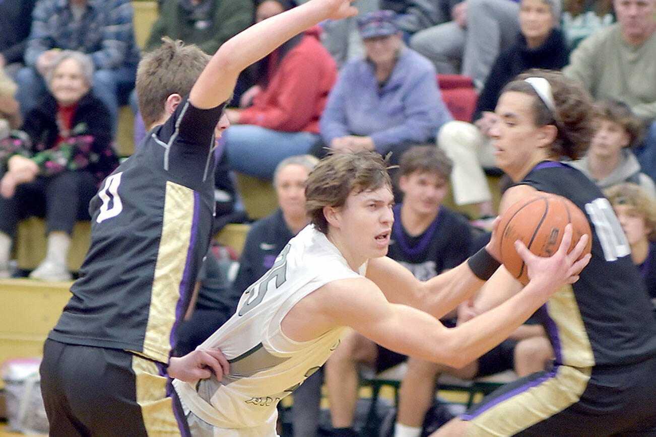 KEITH THORPE/PENINSULA DAILY NEWS 
Port Angeles' Parker Nickerson, center, pushes between Sequim's Ethan Melnick, left, and Lars Wiker on Tuesday night in Port Angeles.
