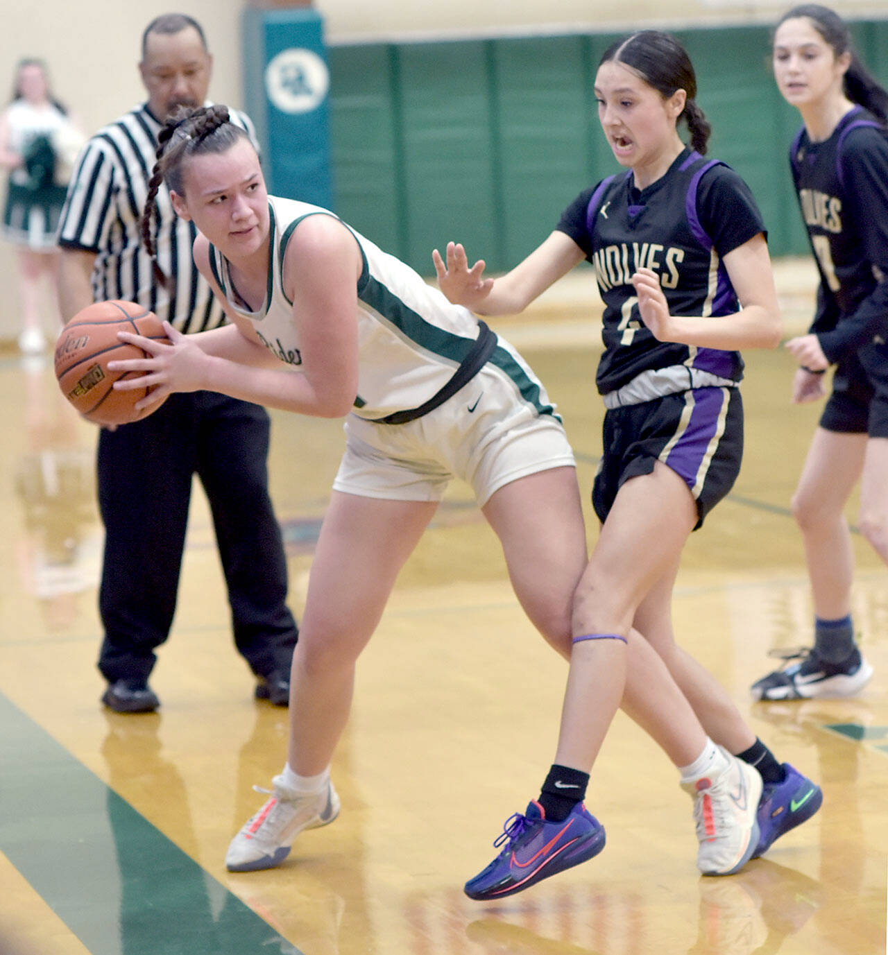 KEITH THORPE/PENINSULA DAILY NEWS 
Port Angeles' Lexie Smith, left, leans out of bounds before passing past the defense of Sequim's Graciela Chartraw on Tuesday night in Port Angeles.