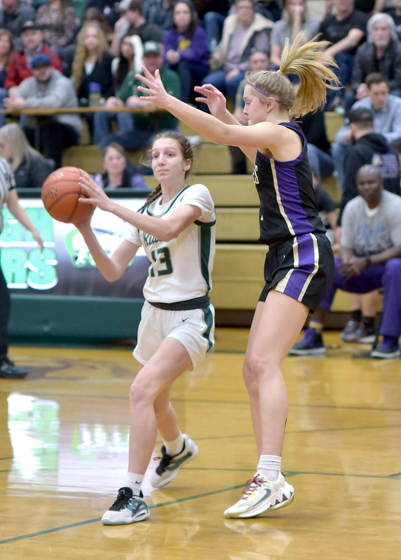 KEITH THORPE/PENINSULA DAILY NEWS Port Angeles’ Morgan Politika, left, looks for her teammates as Sequim’s Jolene Vaara tries to hold her off during Tuesday’s game at Port Angeles High School.