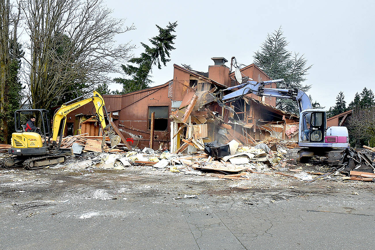 A pair of excavators demolish the former Bushwhacker Restaurant in Port Angeles on Saturday, clearing the space for a future Popeyes Louisiana Kitchen. (Keith Thorpe/Peninsula Daily News)