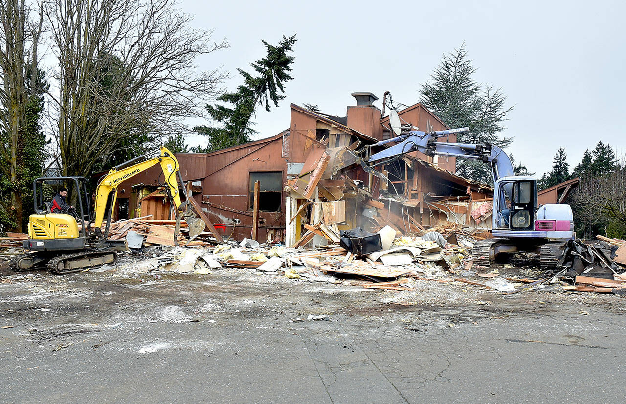 A pair of excavators demolish the former Bushwhacker Restaurant in Port Angeles on Saturday, clearing the space for a future Popeyes Louisiana Kitchen. (Keith Thorpe/Peninsula Daily News)
