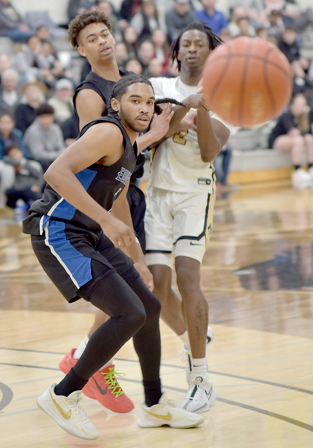 KEITH THORPE/PENINSULA DAILY NEWS 
Peninsula's Ese Onakpoma, right, and Edmonds' Chris Lee, left, and Trevon Hamilton watch an errant ball on Saturday at Peninsula College.