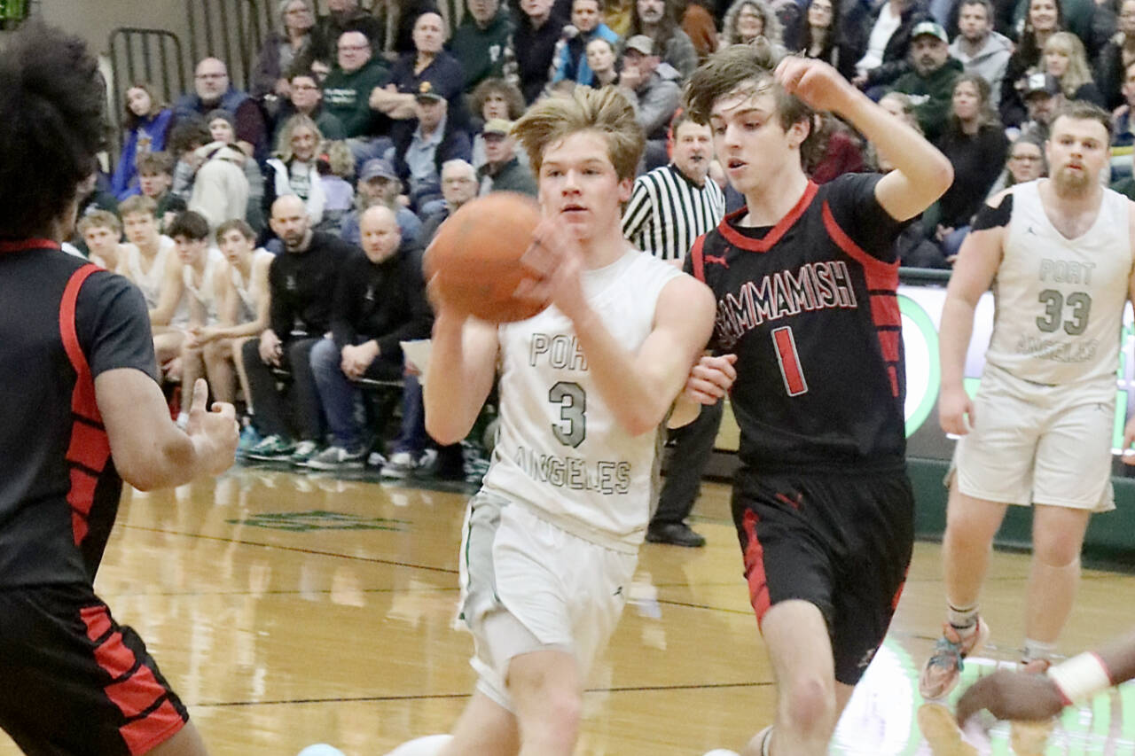 Port Angeles’ Gus Halberg drives the ball against Sammamish on Tuesday night in Port Angeles. The Roughriders lost the district playoff game 65-57, but they are still alive in the postseason and play again at home tonight at 6 p.m. against Steilacoom. (Dave Logan/for Peninsula Daily News)