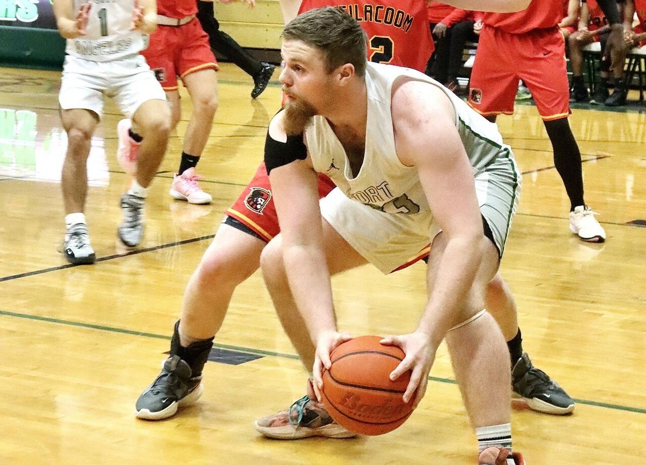 Port Angeles' Ezra Townsend looks to pass against Steilacoom in Port Angeles on Thursday. The Roughriders finished the game on a 33-7 run to come from behind and win 63-49 to move on to a state-qualifying game Saturday against Enumclaw. (Dave Logan/for Peninsula Daily News)