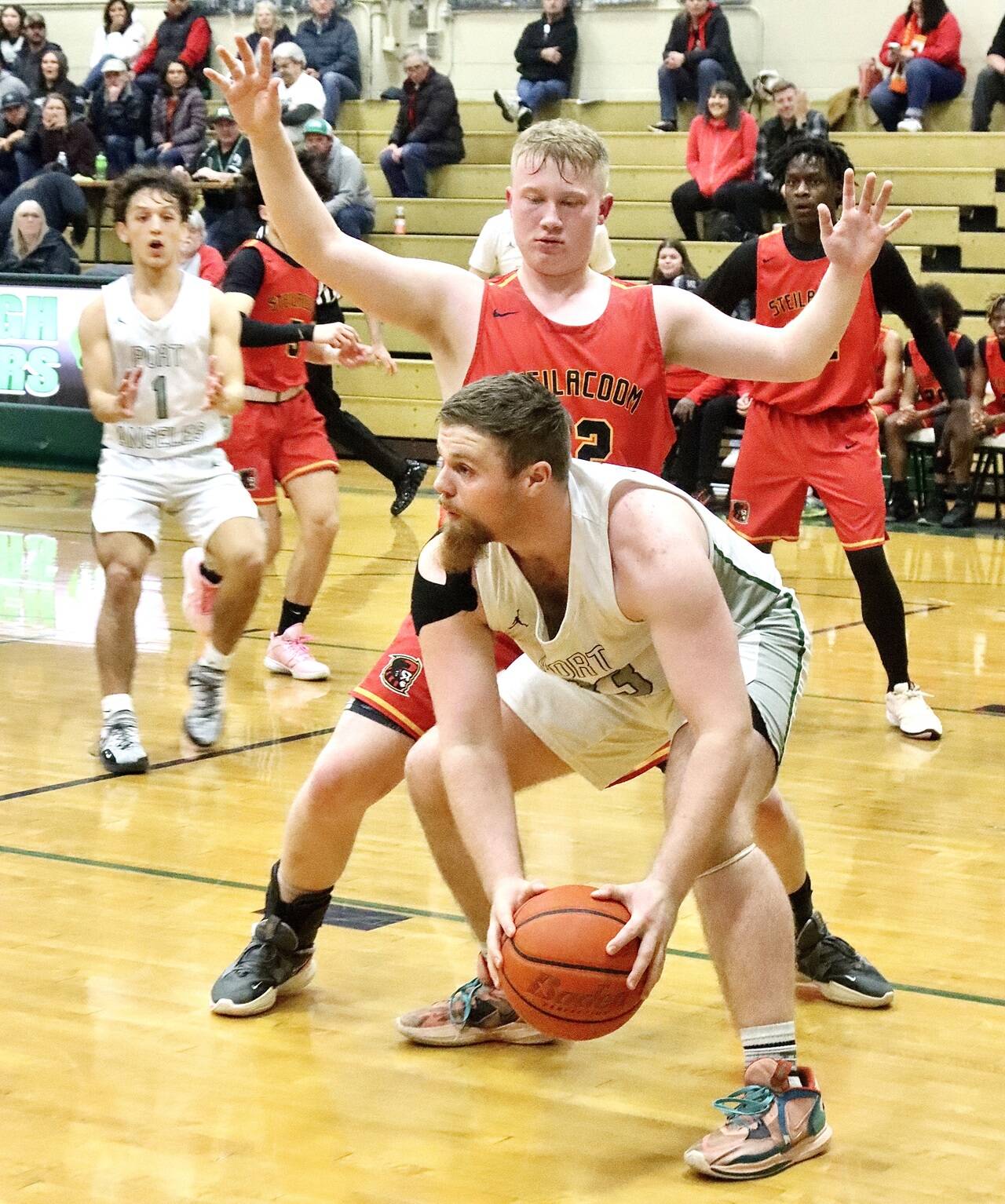 Port Angeles’ Ezra Townsend looks to pass against Steilacoom in Port Angeles on Thursday. The Roughriders finished the game on a 33-7 run to come from behind and win 63-49 to move on to a state-qualifying game Saturday against Enumclaw. (Dave Logan/for Peninsula Daily News)