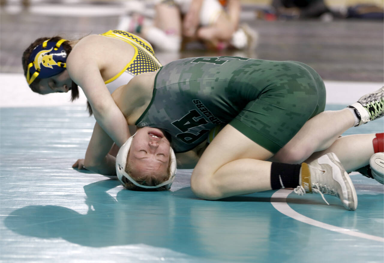 Forks' Peyton Johnson, left, battles Port Angeles' Faye Dachs at the Mat Classic at the Tacoma Dome this weekend. Johnson won with a pin and finished sixth in the state at 115 pounds. Dachs won two matches over the weekend. (Roger Harnack/Cheney Free Press)