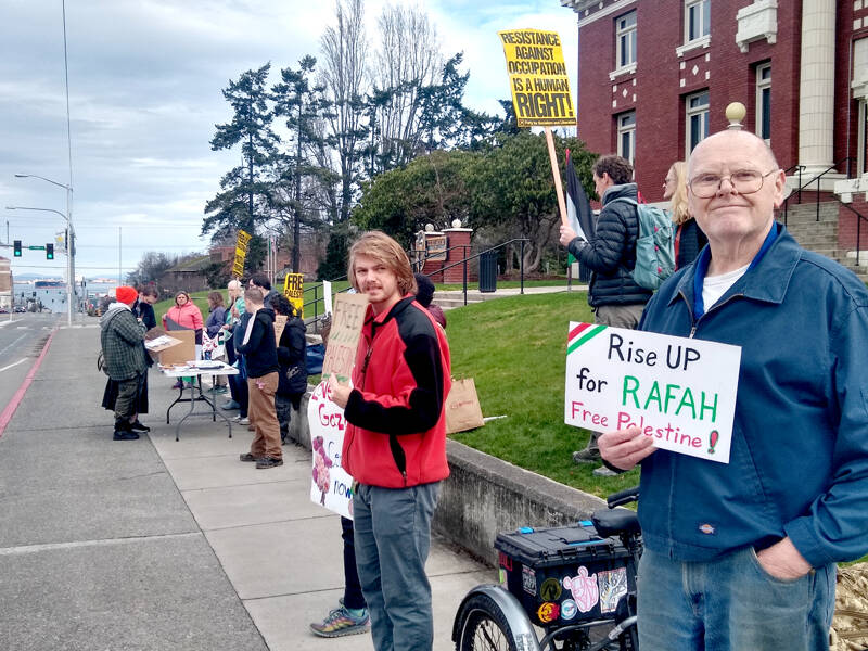 About 25 people, including Warren Musgrove of Port Angeles, far right, rallied in support of Palestine on Saturday in front of the Clallam County Courthouse. The event, also scheduled to run from noon to 1 p.m. this Saturday and March 2, included an information table that provided information about the history of occupation in the Gaza Strip, organizer Christy Cox said. (Lois Danks)