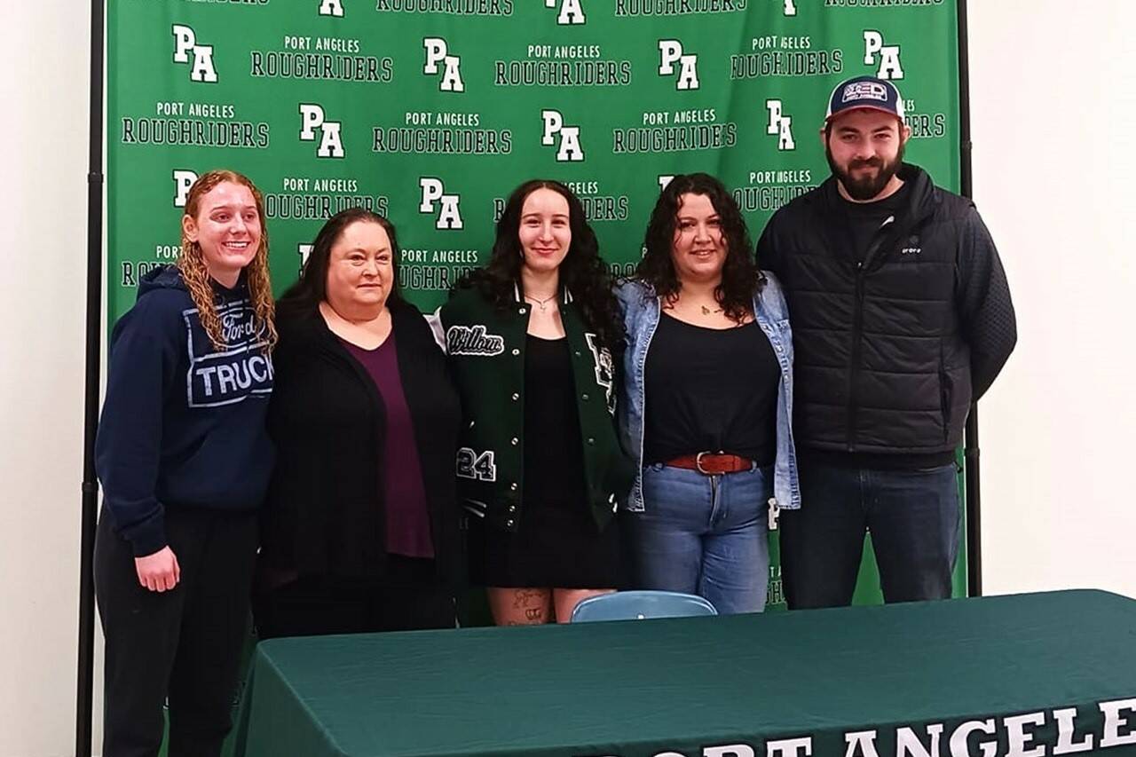 Port Angeles wrestler Willow Harvey is joined by teammates, family and coaches for her college signing Wednesday at Port Angeles High School. From left are teammate Kennedy Brooke, grandmother Lorene Douglas, Harvey, mother Tiffany Cabral and coach Brian Cristion. (Pierre LaBossiere/Peninsula Daily News)