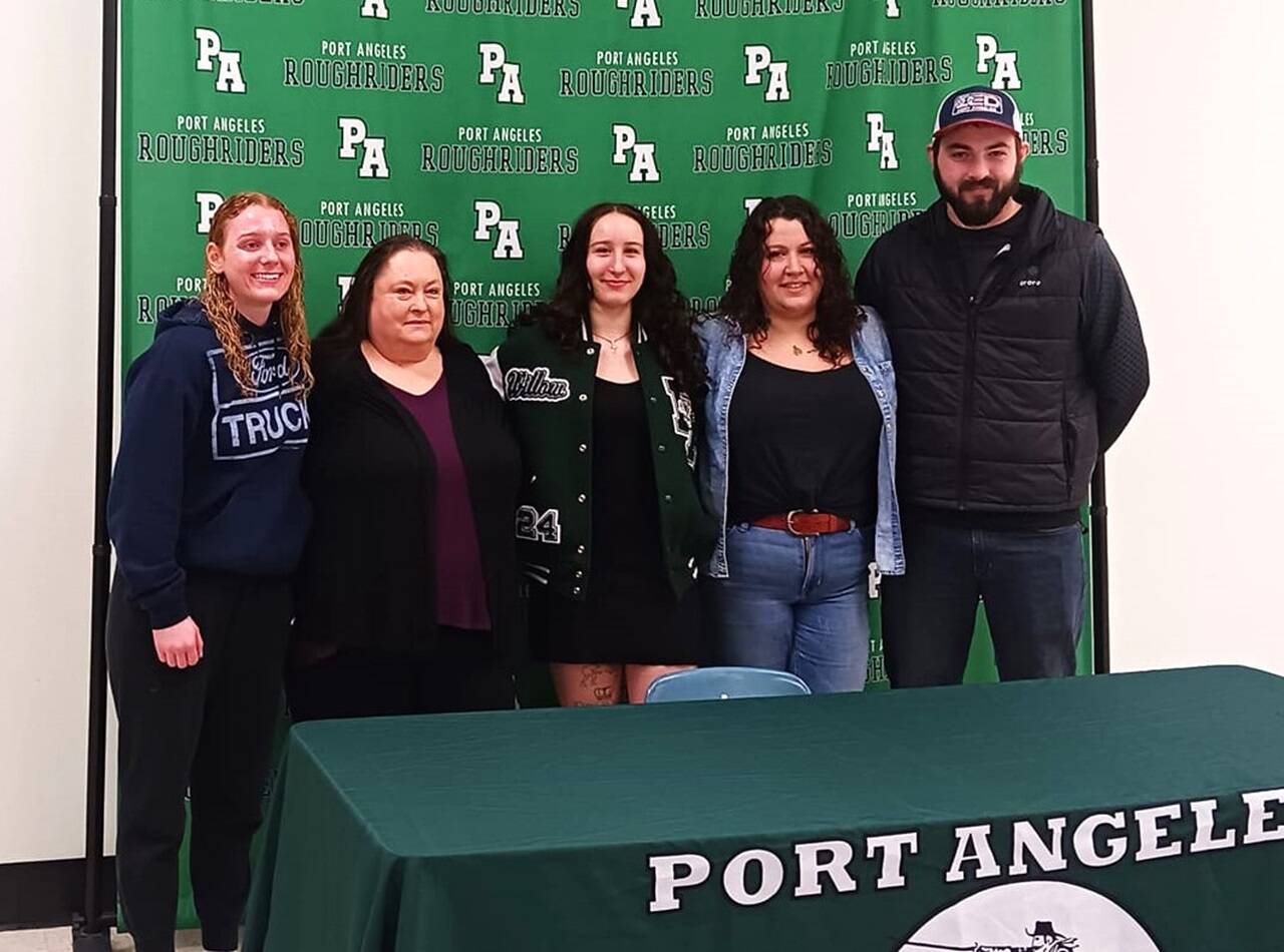 Port Angeles wrestler Willow Harvey is joined by teammates, family and coaches for her college signing Wednesday at Port Angeles High School. From left are teammate Kennedy Bruch, grandmother Lorene Douglas, Harvey, mother Tiffany Cabral and coach Brian Cristion. (Pierre LaBossiere/Peninsula Daily News)