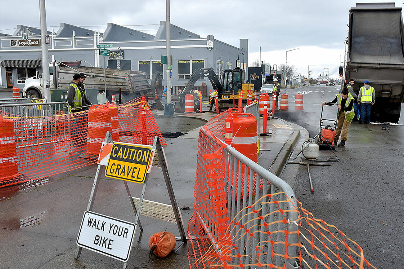 A paving crew from Lakeside Industries replaces pavement on the Waterfront Trail and the entrance to the Port Angeles City Pier parking lot on Wednesday as part of a project to improve sidewalks and storm water drainage around the site. The project is expected to be substantially completed and the parking lot reopened by mid-March. (Keith Thorpe/Peninsula Daily News)