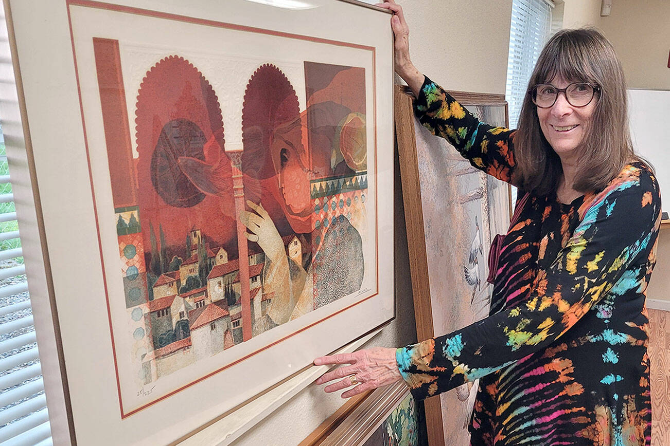 Shipley Center Program Director Reba Renner, program director at the Shipley Center, sorts through more than 80 works of art that will be sold at the center’s art soiree Thursday evening.