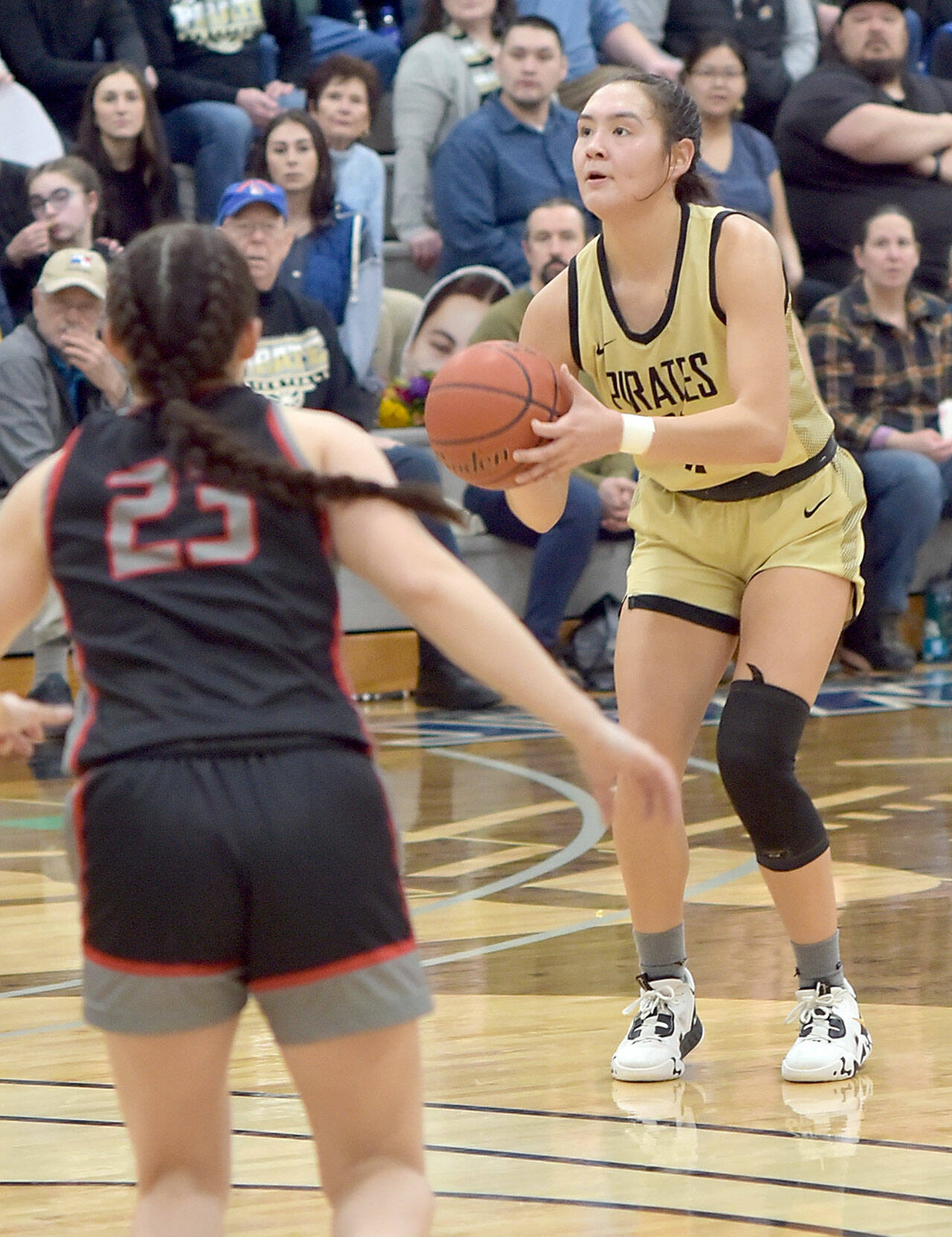 Peninsula’s Jenilee Donovan sets up for a trey as Everett’s Jada Andresen looks on during Saturday’s home finale in Port Angeles. (Keith Thorpe/Peninsula Daily News)