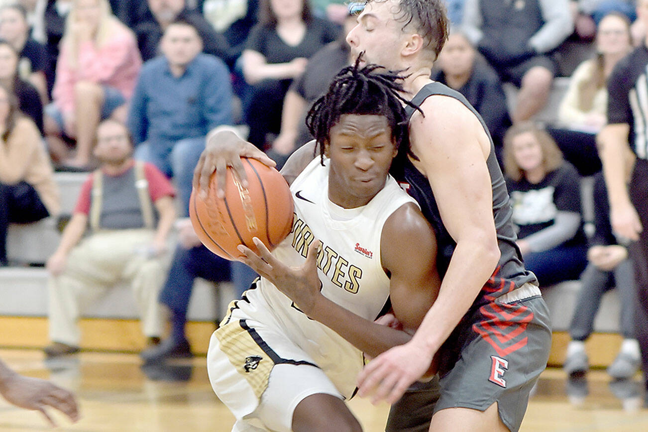 KEITH THORPE/PENINSULA DAILY NEWS
Peninsula's Ese Onakpoma, left, shoulders into Everett's Derek Smith on Saturday in Port Angeles.