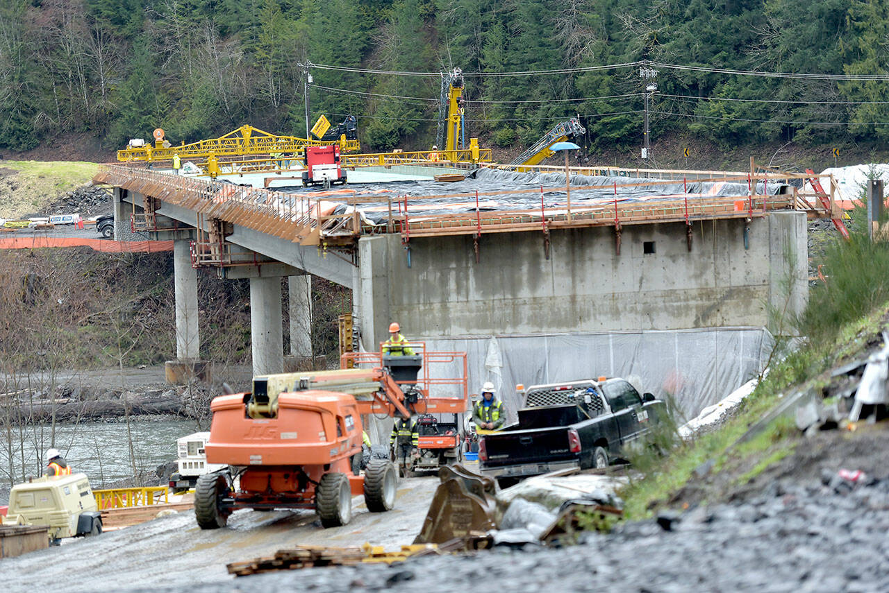 Work progresses on the road deck of the main over-water spans at the site of a new U.S. Highway 101 bridge over the Elwha River southwest of Port Angeles on Thursday. The bridge will replace an older nearby span that was determined to have structurally-deficient pier footings. The $36 million project is expected to be completed in December. (KEITH THORPE/PENINSULA DAILY NEWS)