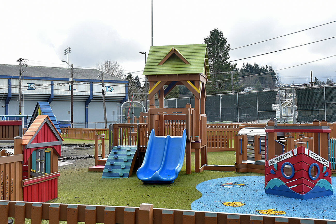 Unburned portions of the Port Angeles Dream Playground at Erickson Playfield stand on Thursday next to an area that was burned in an arson fire in December. (Keith Thorpe/Peninsula Daily News)