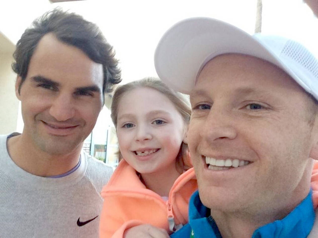 Port Angeles tennis star Jesse Schouten, at right, with his daughter and tennis legend Roger Federer. (Courtesy photo)