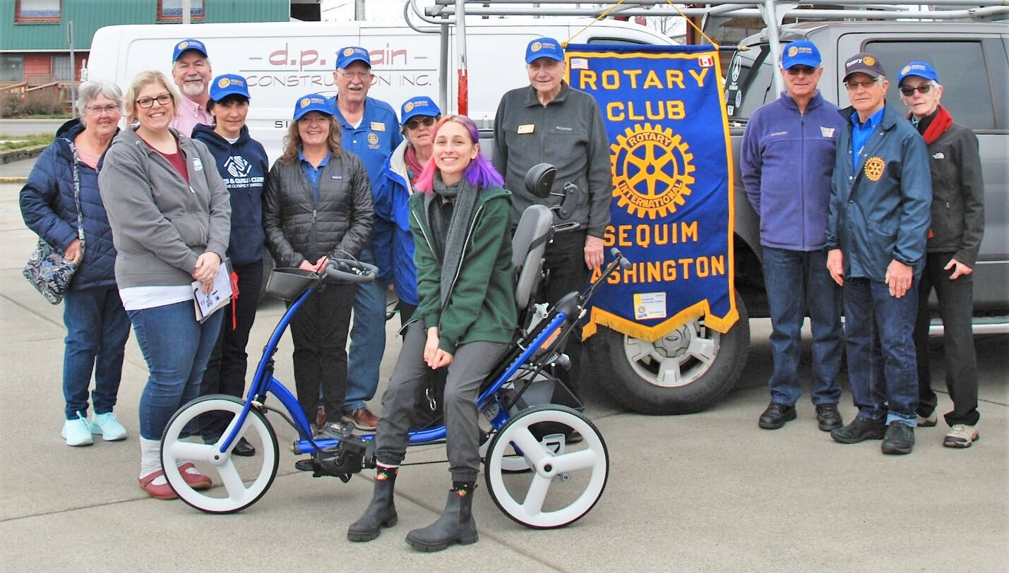 Sequim Noon Rotary members present an adaptive tricycle to representatives from Camp Beausite Northwest in January 2023. Pictured, from left, are Rotarian Judy Shanks; Camp Beausite Northwest Executive Director Raina Baker; Rotarians Stuart Dille, Mary Budke, Anna Richmond, Ted Shanks and Margot Hewitt; camp community development coordinator Tinna Barnet, and Rotarians Ren Garypie, Don Sorensen, Bob Macaulay and Kelly Macaulay.