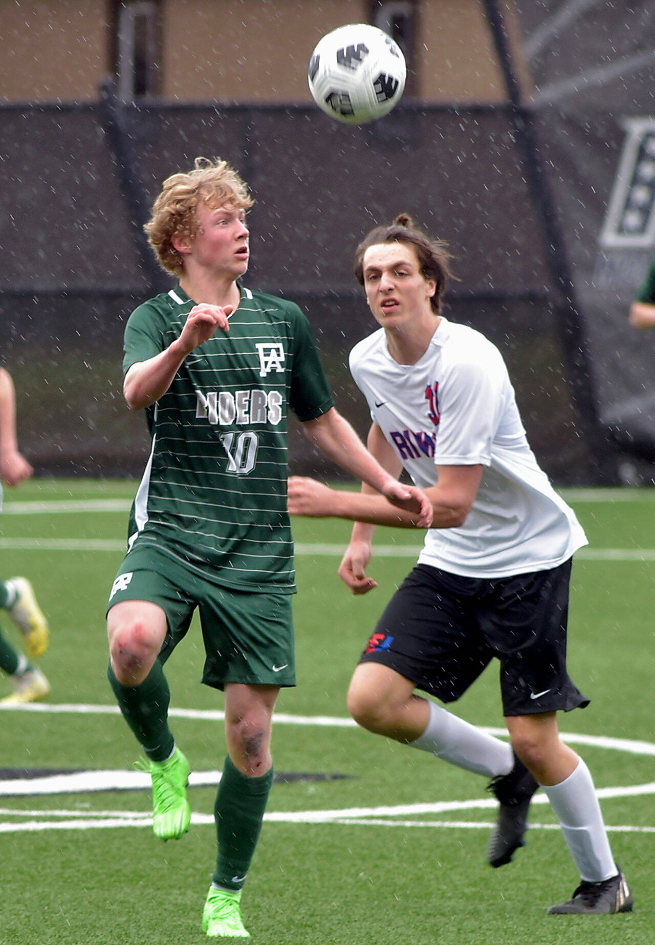 Port Angeles’ Matthew Miller, left, takes control of the ball ahead of East Jefferson’s Zephyr Bell on Saturday at Peninsula College. (Keith Thorpe/Peninsula Daily News)